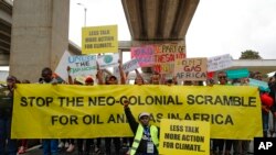 Protesters pose as they demand action on climate change, during a demonstration, in Nairobi, Kenya, Monday, Sept. 4, 2023,