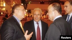 Members of the Syrian opposition chat with Nasser al-Qudwa, deputy to the Arab League and U.N. envoy to Syria, at the meeting of the General Assembly of the Syrian National Council, in Doha, Qatar, November 8, 2012. 