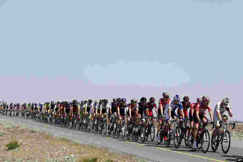 Cyclists ride through the desert during the first stage of the Tour of Oman, 168.5 km from al-Suwaiq Fort to al-Naseem Park in the North Batna province, north of the capital Muscat.