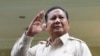 FILE - Indonesian Defense Minister Prabowo Subianto waves at journalists in Jakarta, Indonesia, Feb. 20, 2024.