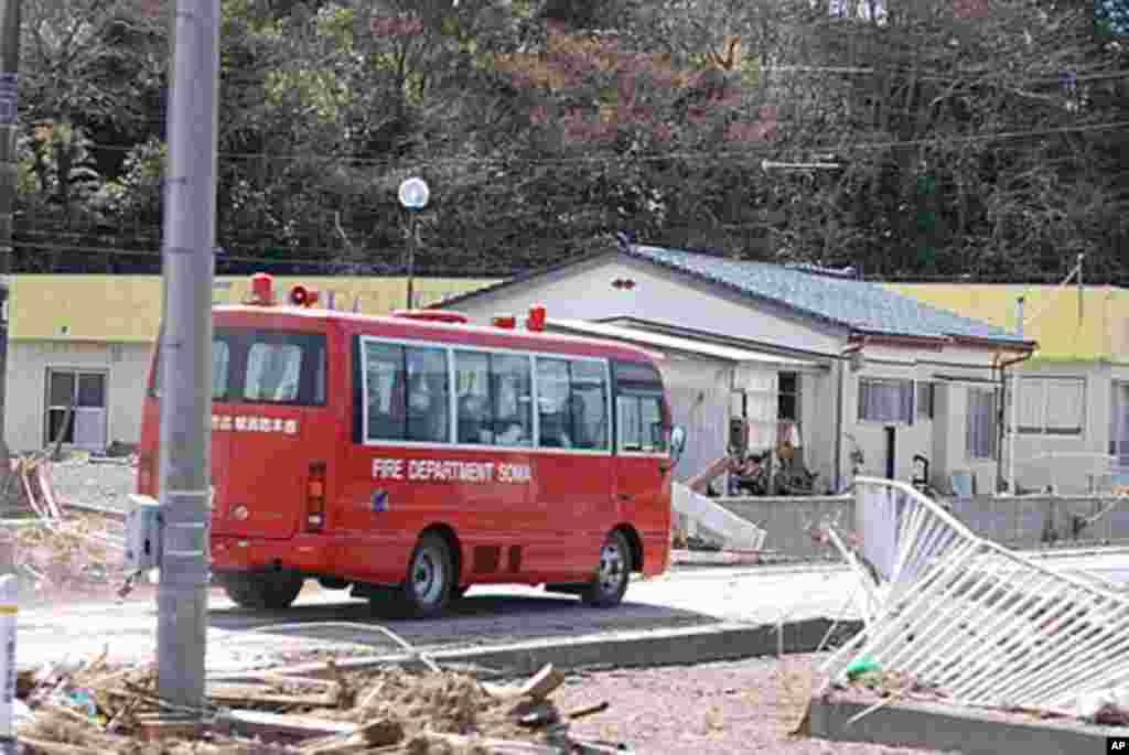 A Soma Fire Department vehicle inspecting tsunami-damaged areas, Namie, Fukushima Pref., Japan 12 March, 2011 (VOA - S. L. Herman)
