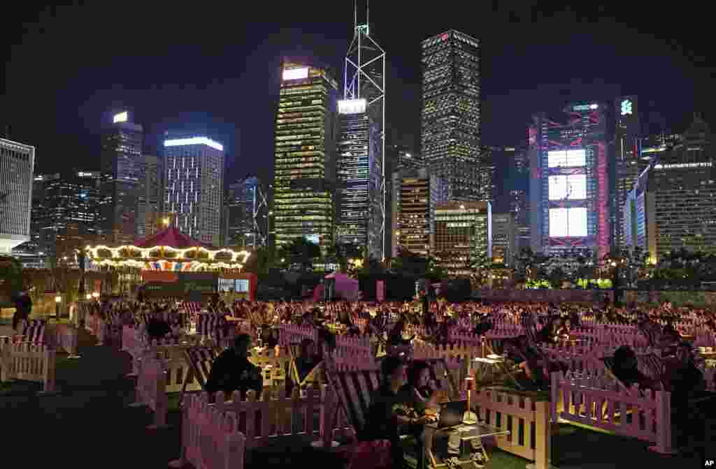 People watch a movie in an outdoor park in Hong Kong.