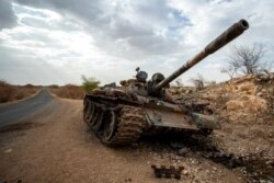 FILE - A destroyed tank is seen by the side of the road south of Humera, in an area of western Tigray annexed by the Amhara region during the ongoing conflict, in Ethiopia, May 1, 2021.