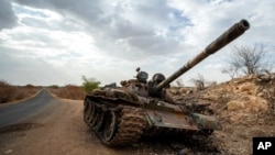 FILE - A destroyed tank is seen by the side of the road south of Humera, in an area of western Tigray annexed by the Amhara region during the ongoing conflict, in Ethiopia, May 1, 2021. 