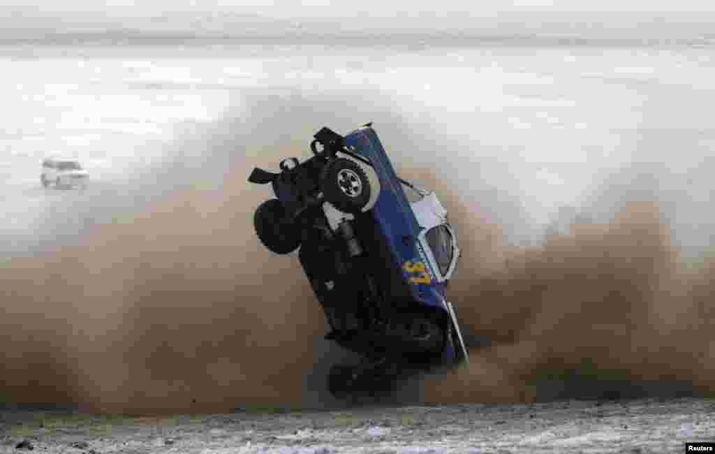 A car overturns during the Master Cross Race 2014 at Suuj Uul, outside Ulan Bator, Mongolia, Dec. 14, 2014.