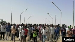 FILE: Sudanese demonstrators march and chant during a protest against the military takeover, in Atbara, Sudan, Oct. 27, 2021 in this social media image.