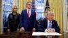 U.S. President Donald Trump signs an executive order in the Oval Office at the White House