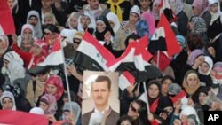 Wafuasi wa Rais Bashar al-Assad wa Syria wakiandamana katika mji wa kaskazini wa Aleppo, March 27, 2011