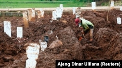 Seorang pekerja menyiapkan kuburan baru di area yang disediakan pemerintah untuk korban COVID-19, Jakarta, 2 Februari 2021. (Foto: REUTERS/Ajeng Dinar Ulfiana)