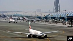 FILE - An Emirates airline passenger jet taxis on the tarmac at Dubai International airport in Dubai, United Arab Emirates.