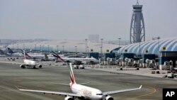 FILE - An Emirates airline passenger jet taxis on the tarmac at Dubai International airport in Dubai, United Arab Emirates.