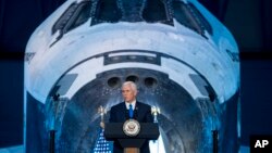 FILE - Vice President Mike Pence delivers opening remarks during the National Space Council's first meeting at the Smithsonian National Air and Space Museum's Steven F. Udvar-Hazy Center in Chantilly, Va., Oct. 5, 2017. The groups met for the second time Wednesday, at Florida's Kennedy Space Center.