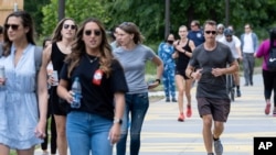 People go massless on the Atlanta Beltline on Friday, May 14, 2021, after the CDC updated their mask guidelines for COVID-19 vaccinated people. (AP Photo/Ben Gray)