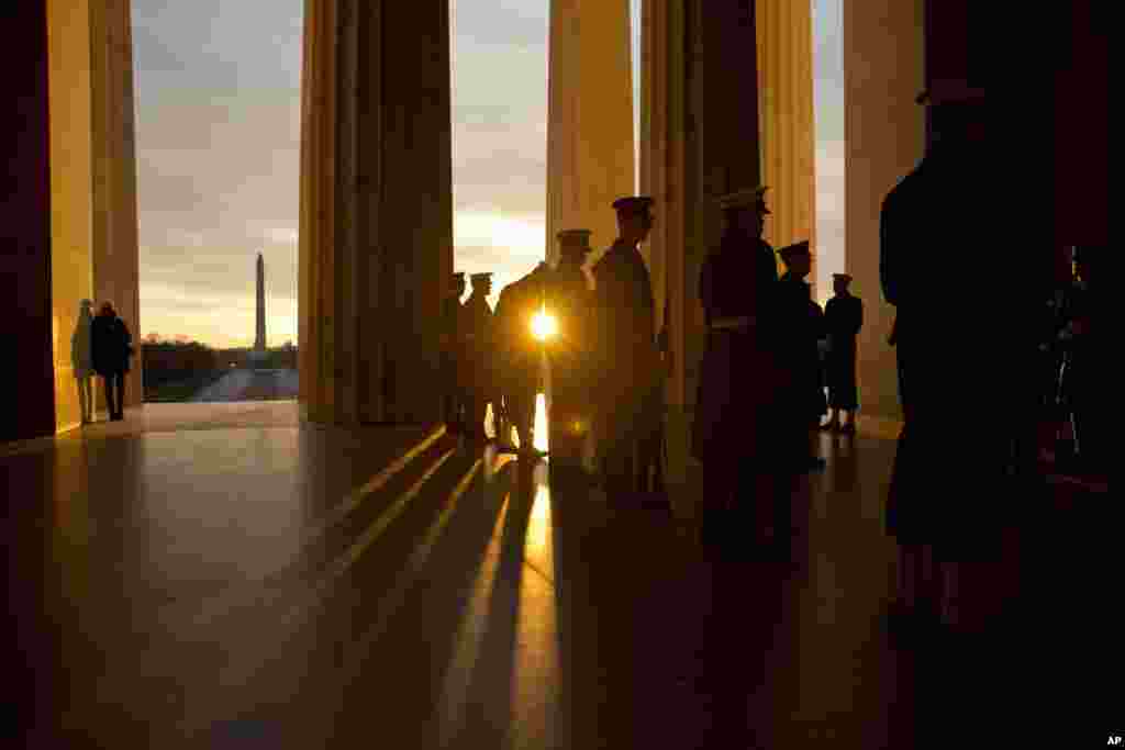 As the sun rises, military personnel practice during a rehearsal before a presidential full honor wreath-laying ceremony in celebration of the 207th birthday of President Abraham Lincoln at the Lincoln Memorial in Washington D.C.
