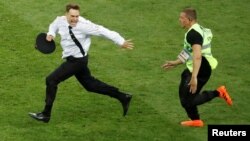 FILE PHOTO: On July 15, 2018, Pitch invader Pyotr Verzilov is chased by a steward during the World Cup final between France and Croatia.