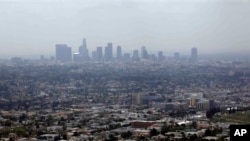 FILE - Smog covers downtown Los Angeles, April 28, 2009.