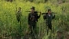 FILE - Rebel soldiers of Myanmar National Democratic Alliance Army (MNDAA) patrol near a military base in Kokang region, March 10, 2015. 