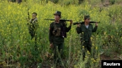 Rebel soldiers of Myanmar National Democratic Alliance Army (MNDAA) patrol near a military base in Kokang region, March 10, 2015. Myanmar government forces have been battling rebels on the border with China since last month and China has urged Myanmar to "lower the temperature."