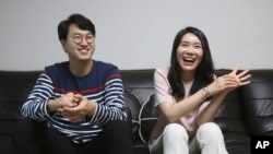 North Korean refugee Kim Seo-yun and her South Korean husband Lee Jeong-sup smile during an interview at their house in Seoul, South Korea Thursday, July 23, 2020. (AP Photo/Ahn Young-joon)