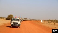 FILE - A convoy of vehicles of the Coalition of the People of Azawad (CPA) are seen patrolling an area near the Mali-Mauritania border to protect local populations from insecurity related to unrest caused by bandits, in Soumpi, Jan. 22, 2020.