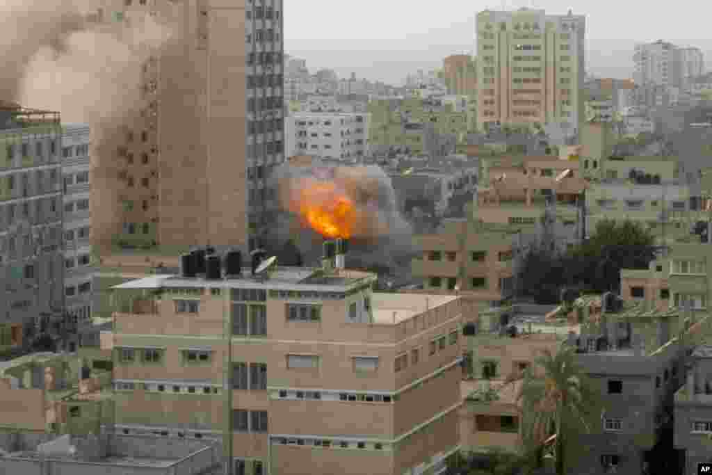 Smoke and fire are seen from an explosion by a high rise housing media organizations in Gaza City, Nov. 19, 2012.