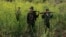 FILE - Rebel soldiers of Myanmar National Democratic Alliance Army (MNDAA) patrol near a military base in Kokang region, March 10, 2015. 