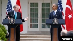 Turkish Prime Minister Recep Tayyip Erdogan, left, answers a question as he and U.S. President Barack Obama hold a joint news conference, White House Rose Garden, Washington, May 16, 2013.