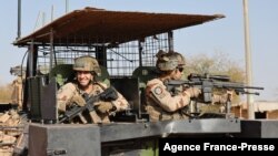 FILE - French soldiers of the Barkhane force patrol the streets of Timbuktu, northern Mali, Dec. 5, 2021. France's anti-jihadist military force in the Sahel region, which involves over 5,000 troops, will end in the first quarter of 2022.