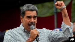 FILE - Venezuela's President Nicolas Maduro addresses government loyalists gathered at the presidential palace in support of his reelection one month after the presidential vote, in Caracas, Venezuela, Aug. 28, 2024. 