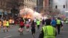 FILE- Runners continue to run towards the finish line of the Boston Marathon as an explosion erupts in this photo exclusively licensed to Reuters by photographer Dan Lampariello, in Boston, Massachusetts, April 15, 2013.