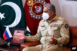 FILE - Pakistan's Army Chief Gen. Qamar Javed Bajwa gestures during his talks with Russian Foreign Minister Sergey Lavrov in Islamabad, Pakistan, in Islamabad, April 7, 2021.
