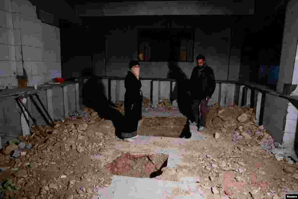 Hayat al-Turki, 27, searches a room inside Sednaya prison, hoping to find her relatives, in Sednaya, Dec. 11, 2024