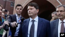 Devin Sloane, center, leaves federal court after his sentencing in a nationwide college admissions bribery scandal, Sept. 24, 2019, in Boston. 