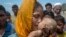 A Rohingya Muslim woman Hanida Begum, who crossed over from Myanmar into Bangladesh, kisses her infant son Abdul Masood who died when the boat they were traveling was capsized just before reaching the shore of the Bay of Bengal, in Shah Porir Dwip, Bangladesh.