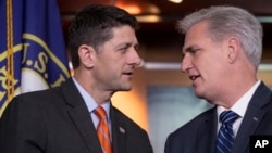 Speaker of the House Paul Ryan, R-Wis., left, confers with House Majority Leader Kevin McCarthy, R-Calif., during a news conference on Capitol Hill in Washington, May 16, 2018. The GOP leadership praised the work of the Agriculture Committee in crafting the farm bill which conservative Republicans scuttled in an immigration protest.