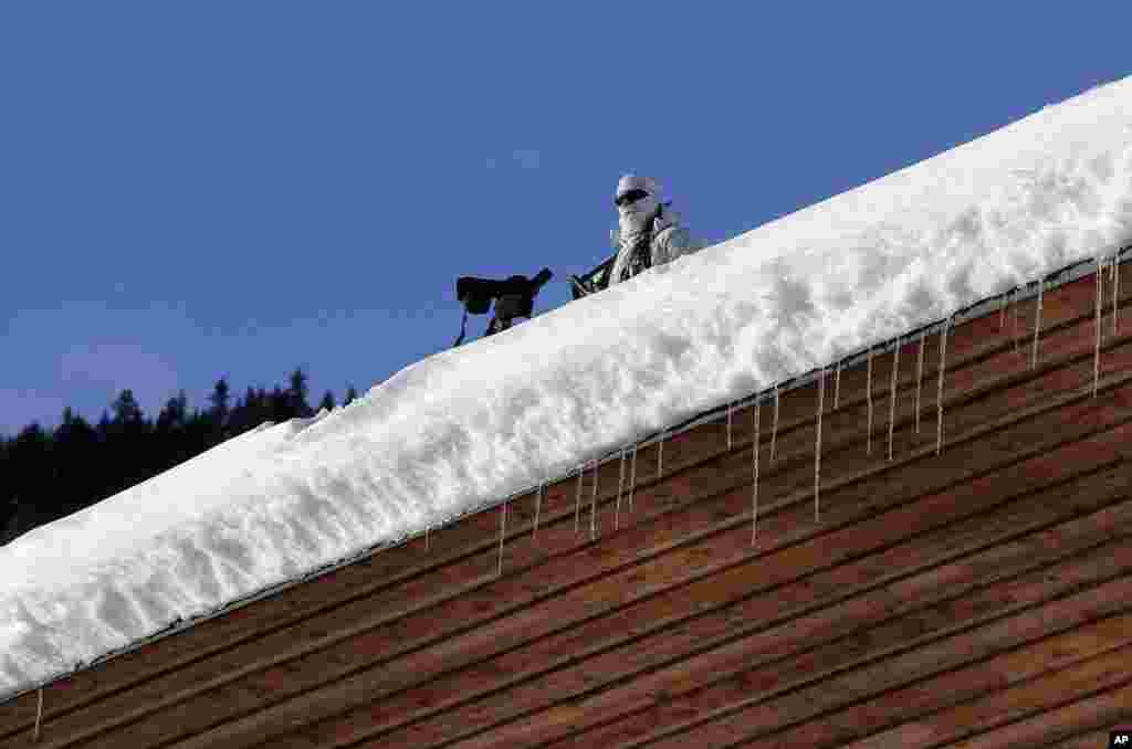 A police officer stands guard on a roof at the annual meeting of the World Economic Forum in Davos, Switzerland.