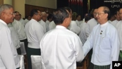 Burmese President Thein Sein, right, greets fellow Union Solidarity and Development Party members, Naypyitaw, Oct. 14, 2012.