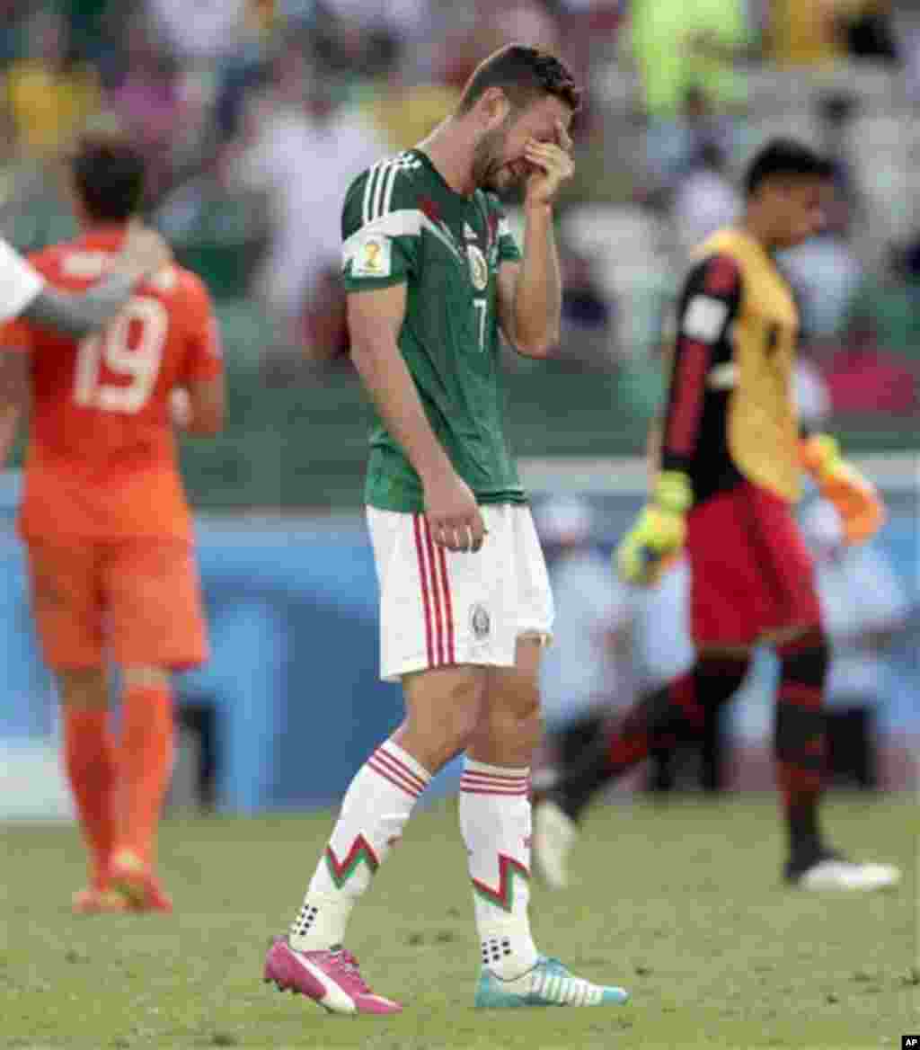 Mexico's Miguel Layun cries at the end of the World Cup round of 16 soccer match between the Netherlands and Mexico at the Arena Castelao in Fortaleza, Brazil, Sunday, June 29, 2014. Netherlands won the match 2-1.(AP Photo/Marcio Jose Sanchez)