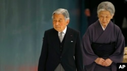 FILE - Japan's Emperor Akihito, accompanied by Empress Michiko, leaves after delivering his remarks during a memorial service at Nippon Budokan martial arts hall in Tokyo, Aug. 15, 2015. 