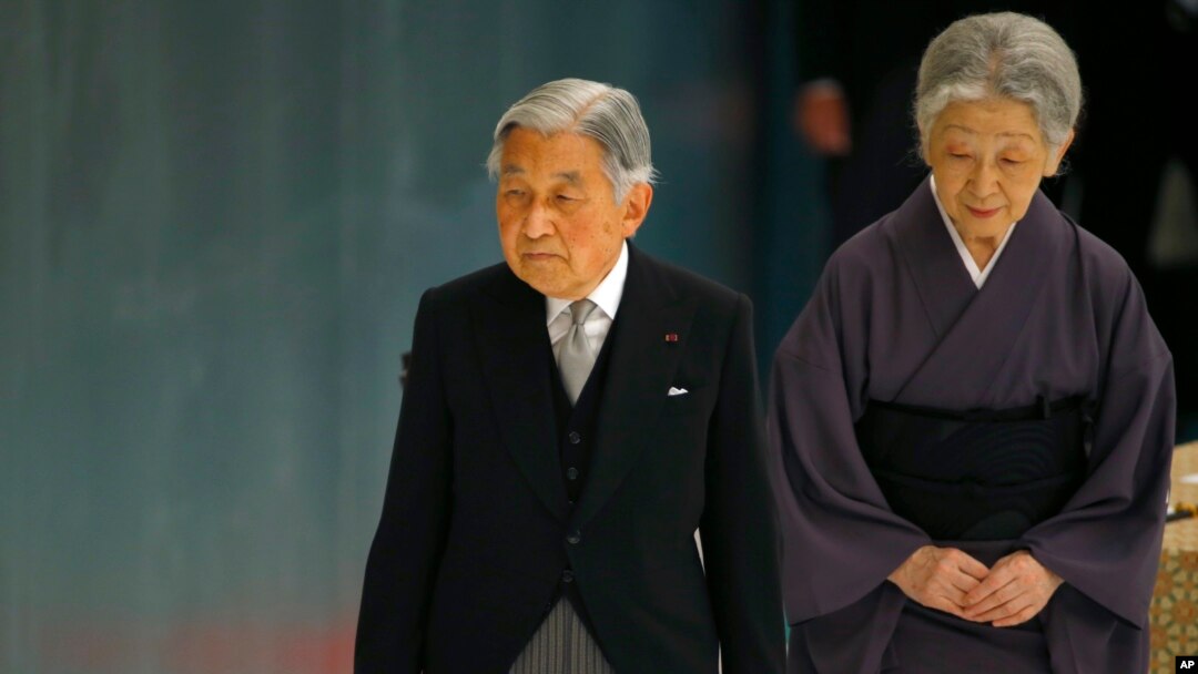FILE - Japan's Emperor Akihito, accompanied by Empress Michiko, leaves after delivering his remarks during a memorial service at Nippon Budokan martial arts hall in Tokyo, Aug. 15, 2015. 