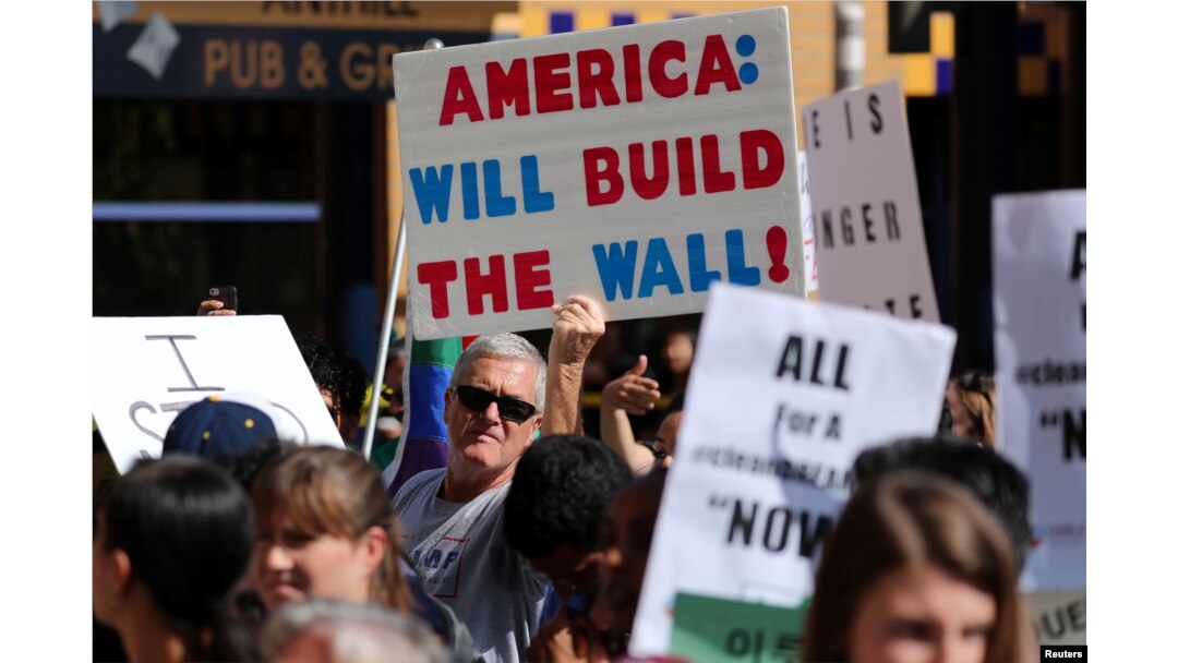 FILE - Pro-Trump supporters try to interrupt a speech by Sen. Kamala Harris, D-Calif., at a rally in support of the Deferred Action for Childhood Arrivals program at the University of California-Irvine, Oct. 11, 2017.