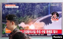 A South Korean soldier walks past a TV broadcast of a news report on North Korea firing what appeared to be several land-to-ship missiles off its east coast, at a railway station in Seoul, South Korea, June 8, 2017.