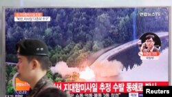 A South Korean soldier walks past a TV broadcast of a news report on North Korea firing what appeared to be several land-to-ship missiles off its east coast, at a railway station in Seoul, South Korea, June 8, 2017.