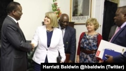 FILE: President Emmerson Mnangagwa and Foreign Affairs Minister SIbusiso Moyo with some British officials in Harare 