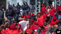 Supporters of Julius Malema's opposition Economic Freedom Fighters (EFF) party who were upset with the election results stage a protest outside the provincial results center for Gauteng province in Johannesburg, South Africa Friday, May 9, 2014. Vote-coun