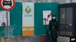 A paramilitary police officer stands guard in an area near the Great Hall of the People, where delegates are attending the opening session of the Chinese People's Political Consultative Conference (CPPCC) held in Beijing on March 4, 2021.