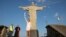 Brazil's former volleyball player Isabel Barroso Salgado carries the Olympic torch in front of the Christ the Redeemer statue on its way for the opening ceremony of Rio's 2016 Summer Olympics in Rio de Janeiro, Brazil, Aug. 5, 2016. 
