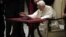 Pope Benedict XVI watches a tablet at the Vatican, in Rome, December 12, 2012.