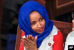 In this Feb. 5, 2019, file photo, Rep. Ilhan Omar, D-Minn., listens to President Donald Trump's State of the Union speech, at the Capitol in Washington.