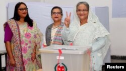Prime Minister Sheikh Hasina gestures after casting her vote in the morning during the general election in Dhaka, Bangladesh, Dec. 30, 2018.